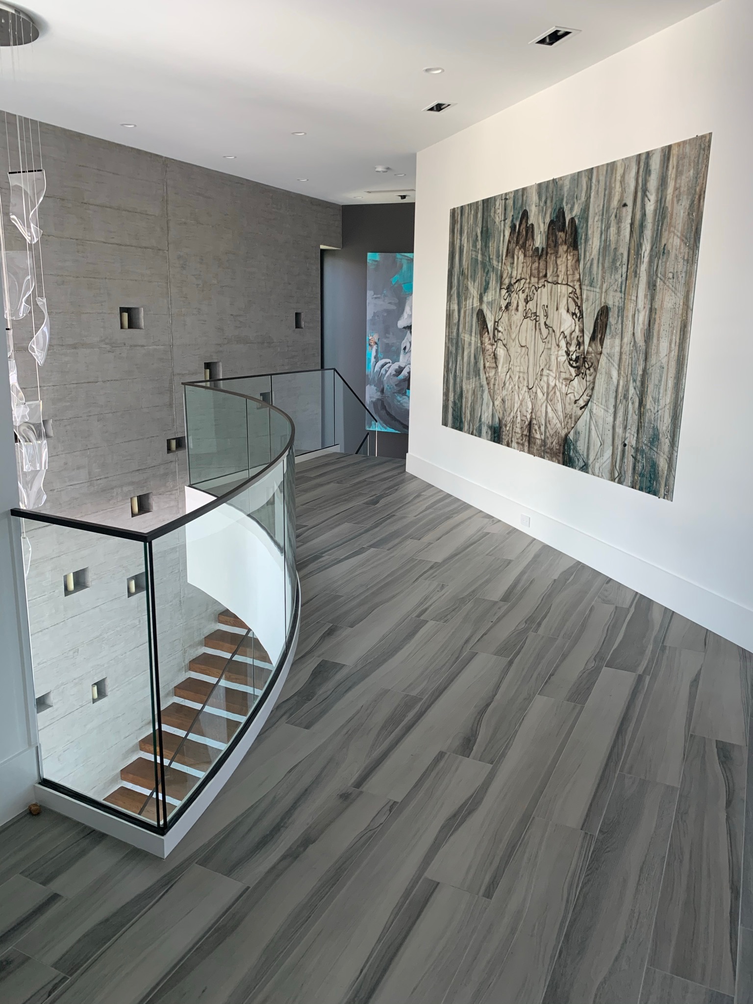 Wide plank stone flooring in a curved staircase gallery